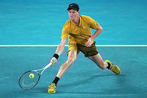 Jannik Sinner of Italy plays a forehand return to Eliot Spizzirri of the U.S. during their third round match at the Australian Open tennis championship in Melbourne, Australia.