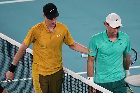 Jannik Sinner, left, of Italy walks from the court with Eliot Spizzirri of the U.S. after winning their third round match at the Australian Open tennis championship in Melbourne, Australia.