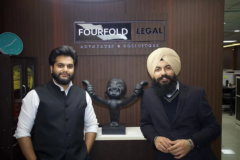 Two men in professional attire standing in an office lobby