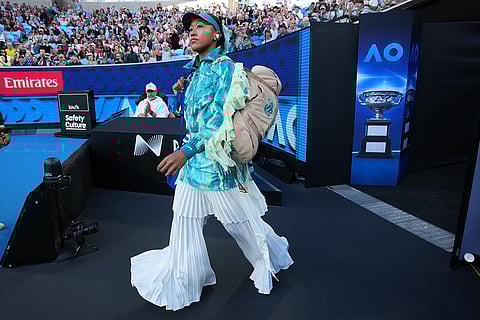 Naomi Osaka of Japan walks onto court for her second round match against Sorana Cirstea of Romaniaat the Australian Open tennis championship in Melbourne, Australia, Thursday, Jan. 22, 2026.