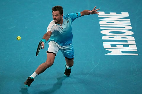 Stan Wawrinka of Switzerland plays a backhand return to Taylor Fritz of the U.S. during their third round match at the Australian Open tennis championship in Melbourne, Australia.
