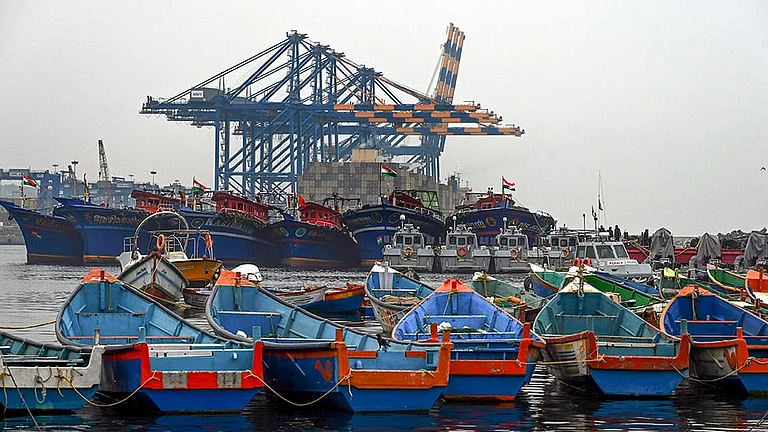 Fishing boats remain anchored against the backdrop of Vizhinjam International Seaport in the wake of bad weather and the impact of cyclonic storm Ditwah, in Thiruvananthapuram. - | Photo: PTI