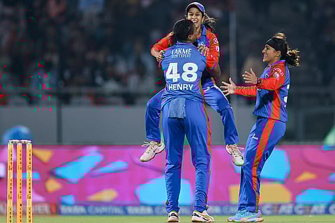 Delhi Capitals' Chinelle Henry celebrates with teammates Jemimah Rodrigues and Sneh Rana after taking the wicket of Royal Challengers Bengaluru's Nadine de Klerk during the Women's Premier League (WPL) 2026 T20 cricket match between Royal Challengers Bengaluru and Delhi Capitals, at BCA Stadium, in Vadodara, Gujarat.