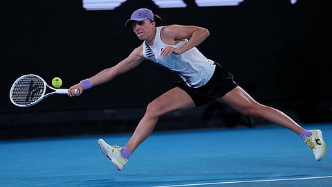 Iga Swiatek of Poland plays a forehand return to Anna Kalinskaya of Russia during their third round match at the Australian Open tennis championship in Melbourne, Australia.