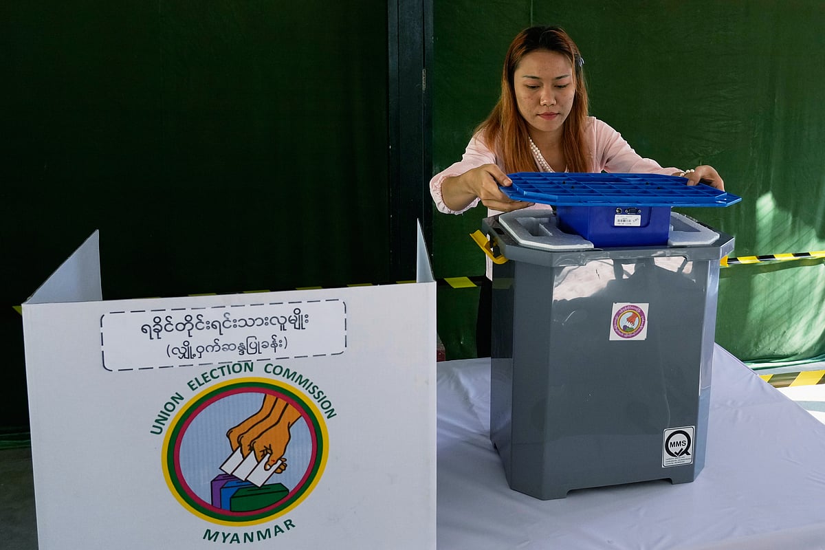 A official of the Union Election Commission prepares a voting booth at a polling station, one day ahead of the third phase of the general election, in Yangon, Myanmar, Saturday, Jan. 24, 2026.  - (AP Photo/Thein Zaw)