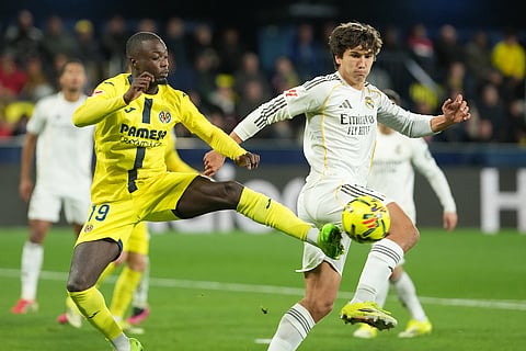 Villarreal's Nicolas Pepe, left, and Real Madrid's Gonzalo Garcia battle for the ball during a Spanish La Liga soccer match between Villarreal and Real Madrid in Villarreal, Spain.