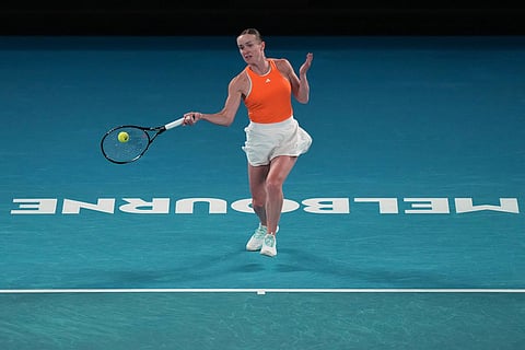 Elina Svitolina of Ukraine plays a forehand return to Mirra Andreeva of Russia during their fourth round match at the Australian Open tennis championship in Melbourne, Australia.