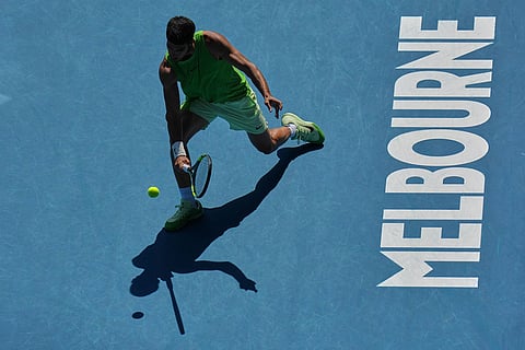 Carlos Alcaraz of Spain plays a backhand return to Tommy Paul of the U.S.during their fourth round match at the Australian Open tennis championship in Melbourne, Australia.