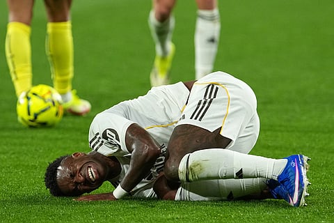 Real Madrid's Vinicius Junior reacts after a challenge during a Spanish La Liga soccer match between Villarreal and Real Madrid in Villarreal, Spain.