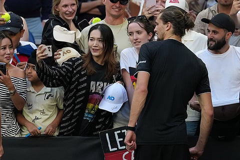 Alexander Zverev of Germany poses for photos after defeating Francisco Cerundolo of Argentina in their fourth round match at the Australian Open tennis championship in Melbourne, Australia.