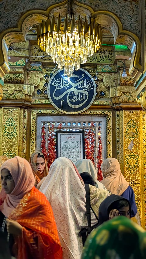 Women offer prayers at the shrine.
