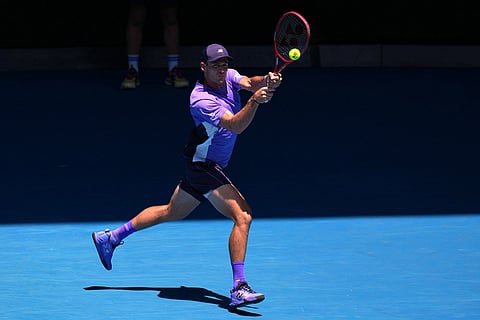 Tommy Paul of the U.S. plays a backhand return to Carlos Alcaraz of Spain during their fourth round match at the Australian Open tennis championship in Melbourne, Australia.