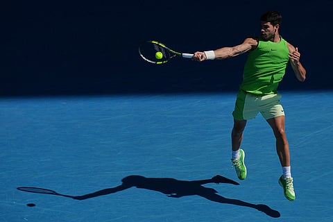 Carlos Alcaraz of Spain plays a forehand return to Tommy Paul of the U.S.during their fourth round match at the Australian Open tennis championship in Melbourne, Australia.