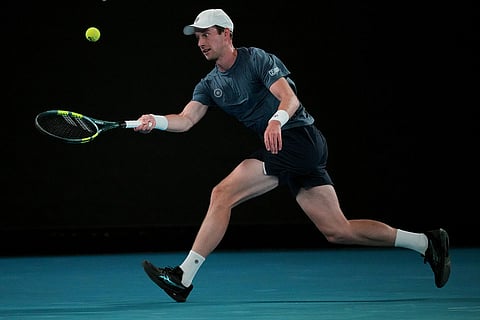 Botic van de Zandschulp of the Netherlands plays a backhand return to Novak Djokovic of Serbia during their third round match at the Australian Open tennis championship in Melbourne, Australia.