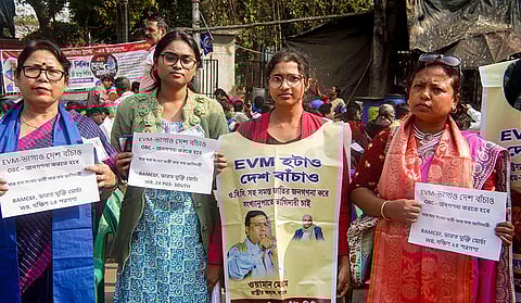 Members of tribal and minority communities take part in a rally demanding the protection of the Constitution, in Kolkata.