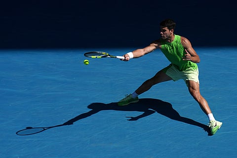 Carlos Alcaraz of Spain plays a forehand return to Tommy Paul of the U.S.during their fourth round match at the Australian Open tennis championship in Melbourne, Australia.