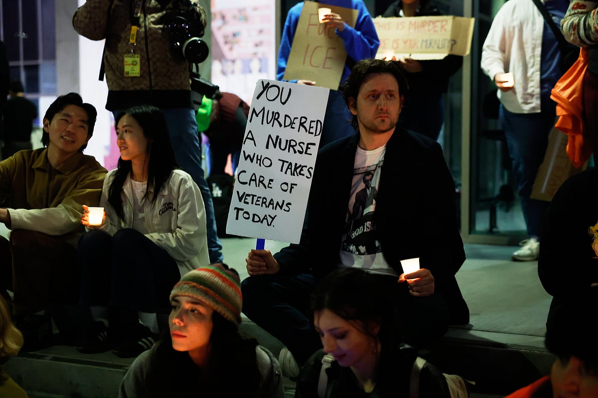 Demonstrator holds a sign during a candlelight vigil during a protest in response to the fatal shooting of 37-year-old Alex Pretti in Minneapolis earlier in the day Saturday, Jan. 24, 2026, in Los Angeles. -  (AP Photo/Caroline Brehman) 