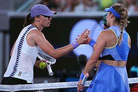 Iga Swiatek, left, of Poland is congratulated by Anna Kalinskaya of Russia following their third round match at the Australian Open tennis championship in Melbourne, Australia.