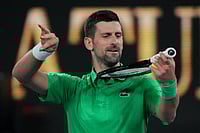 | Photo: AP/Dita Alangkara : Novak Djokovic of Serbia reacts after defeating Botic van de Zandschulp of the Netherlands in their third round match at the Australian Open tennis championship in Melbourne, Australia.