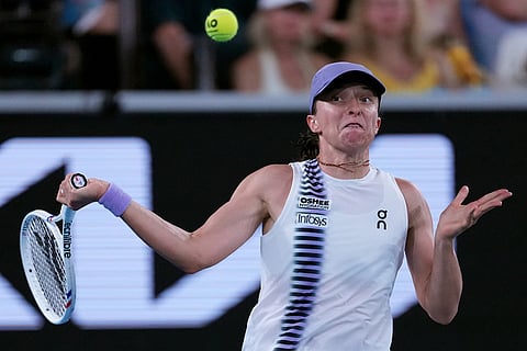 Iga Swiatek of Poland plays a forehand return to Anna Kalinskaya of Russia during their third round match at the Australian Open tennis championship in Melbourne, Australia.