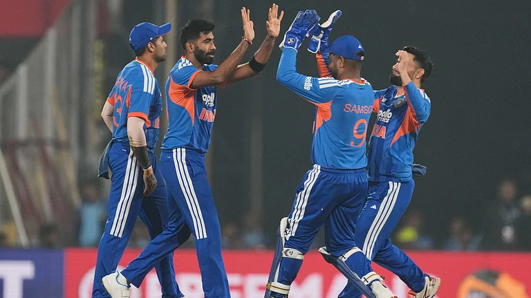 India's Jasprit Bumrah celebrates with teammates after the dismissal of New Zealand's Tim Seifert during the third T20 cricket match on January 25, 2026. - | Photo: AP/Anupam Nath