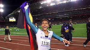 (AP Photo/Thomas Kienzle, File) : In this Sept. 25, 2000, file photo, Australia's Cathy Freeman celebrates winning the women's 400 meter race at the Summer Olympics at Olympic Stadium in Sydney.