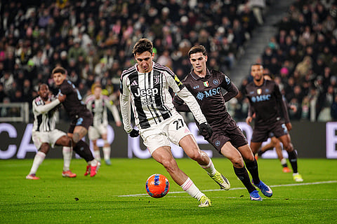 Juventus' Andrea Cambiaso, center, fights for the ball with Napoli's Eljif Elmas during the Italian Serie A soccer match between Juventus and Napoli in Turin, Italy.