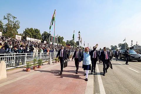 Prime Minister Narendra Modi greets the gathering after the 77th Republic Day Parade, at Kartavya Path, in New Delhi. 