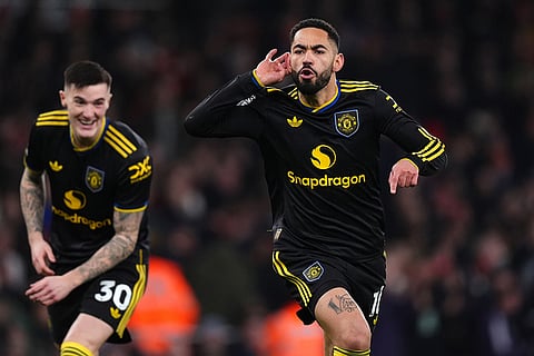 Manchester United's Matheus Cunha celebrates scoring their side's third goal of the game during the English Premier League soccer match between Arsenal and Manchester United in London.