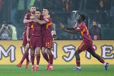 Roma's Lorenzo Pellegrini celebrates with teammates after scoring during the Serie A EniLive soccer match between Roma and Milan in Rome, Italy.