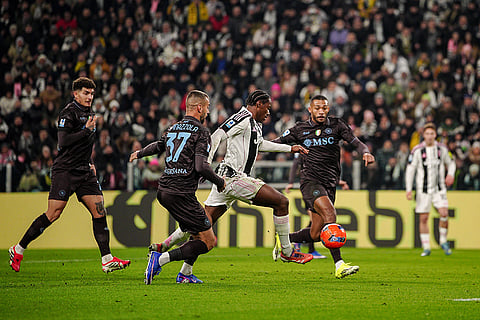 Juventus' Jonathan David, center, scores their side's first goal of the game during the Italian Serie A soccer match between Juventus and Napoli in Turin, Italy.