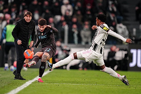 Juventus' Juan Cabal, right, fights for the ball with Napoli's Giovanni Di Lorenzo during the Italian Serie A soccer match between Juventus and Napoli in Turin, Italy.