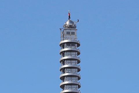 Rock climber Alex Honnold, of the U.S., raises his fist as he climbs on top of the Taipei 101 skyscraper in Taipei, Taiwan.
