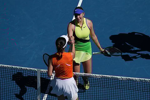 Amanda Anisimova, top, of the U.S., is congratulated by Wang Xinyu of China following her win in their fourth round match at the Australian Open tennis championship in Melbourne, Australia.