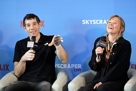 Rock climber Alex Honnold, of the U.S., with his wife Sanni Honnold, speaks as he answers to media members during a news conference after he completed a free solo climb of the Taipei 101 skyscraper in Taipei, Taiwan.