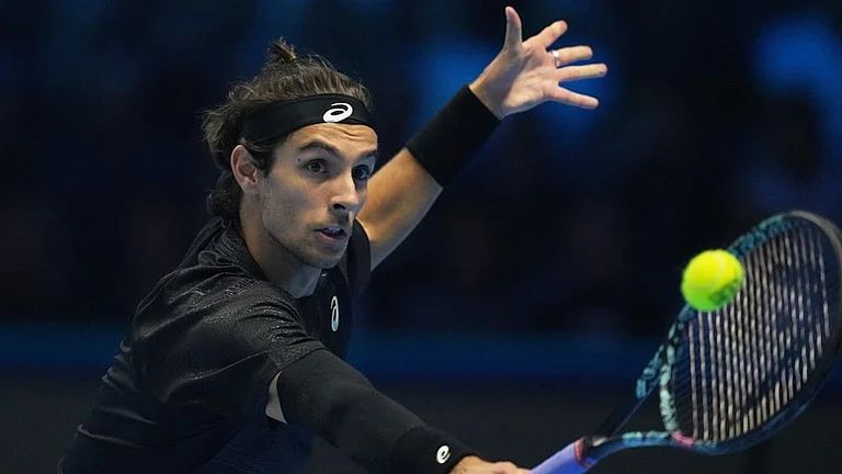 Italy's Lorenzo Musetti returns the ball to Australia's Alex de Minaur during their tennis match of the ATP World Tour Finals, in Turin, Italy. - | Photo: AP/Antonio Calanni