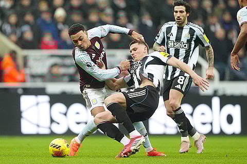 Aston Villa's Morgan Rogers, left, and Newcastle United's Sven Botman battle for the ball during their English Premier League soccer match in Newcastle upon Tyne, England.