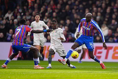 Chelsea's Moises Caicedo is challenged by Crystal Palace's Jean-Philippe Mateta, right, and Ismaila Sarr during the English Premier League soccer match between Crystal Palace and Chelsea in London.