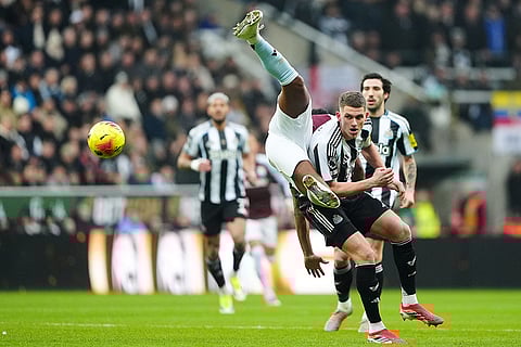 Aston Villa's Ollie Watkins, left, and Newcastle United's Sven Botman battle for the ball during their English Premier League soccer match in Newcastle upon Tyne, England.