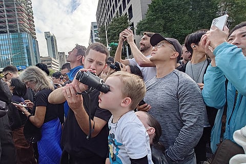 People watch rock climber Alex Honnold, of the U.S., perform a free solo climb of the Taipei 101 skyscraper in Taipei, Taiwan.