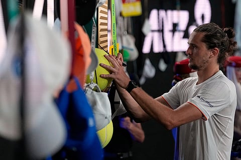 Alexander Zverev of Germany signs autographs after defeating Learner Tien of the U.S. following their quarterfinal match at the Australian Open tennis championship in Melbourne, Australia.