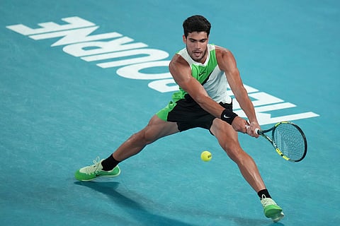 Carlos Alcaraz of Spain plays a backhand return to Alex de Minaur of Australia during their quarterfinal match at the Australian Open tennis championship in Melbourne, Australia.