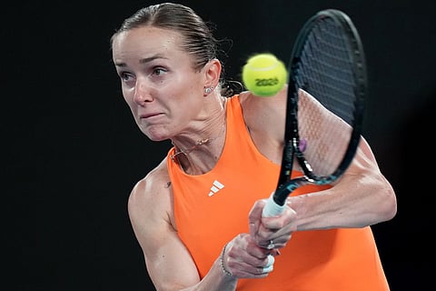 Elina Svitolina of Ukraine plays a backhand return to Coco Gauff of the U.S. during their quarterfinal match at the Australian Open tennis championship in Melbourne, Australia.