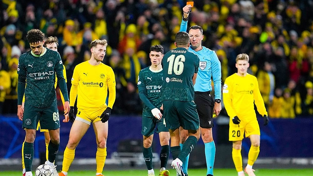 Manchester City's Rodri is shown a red card by referee Sven Jablonski during the Champions League soccer match between Bodo/Glimt and Manchester City in Bodo, Norway. - | Photo: Fredrik Varfjell/NTB via AP