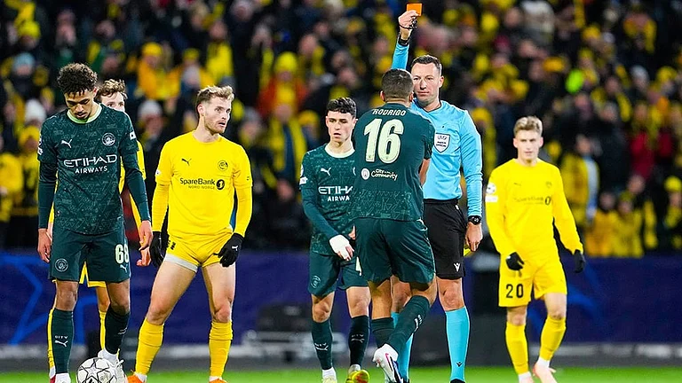 Manchester City's Rodri is shown a red card by referee Sven Jablonski during the Champions League soccer match between Bodo/Glimt and Manchester City in Bodo, Norway. - | Photo: Fredrik Varfjell/NTB via AP