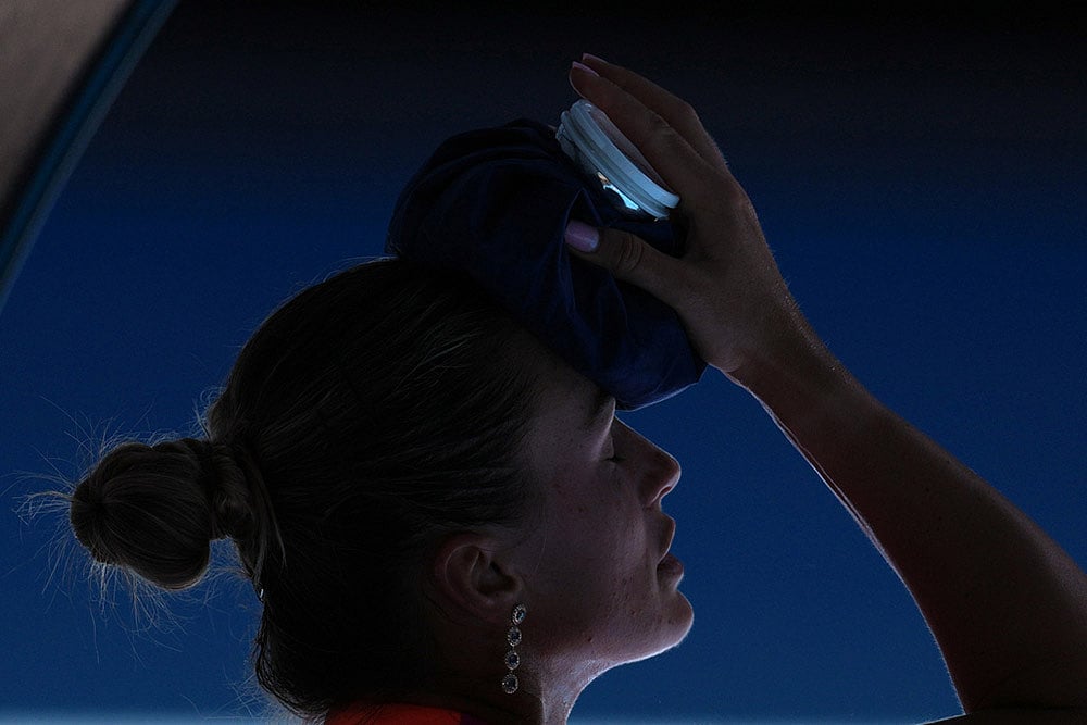Aryna Sabalenka of Belarus places an ice pack to her face during her quarterfinal match