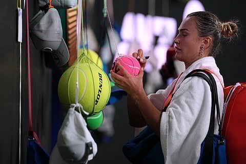 Aryna Sabalenka of Belarus signs autographs after defeating to Iva Jovic of the U.S. in their quarterfinal match at the Australian Open tennis championship in Melbourne, Australia.