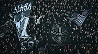 | Photo: AP/Giannis Papanikos. : PAOK's fans wave giant flags of their team during the Europa League match against Real Betis in Thessaloniki, Greece, on Thursday, January 22, 2026.