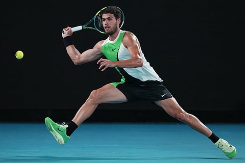 Carlos Alcaraz of Spain plays a forehand return to Alex de Minaur of Australia during their quarterfinal match at the Australian Open tennis championship in Melbourne, Australia.
