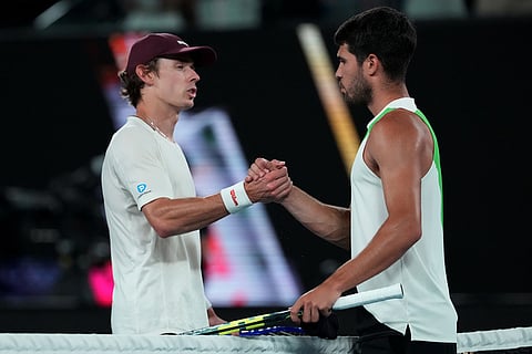 Carlos Alcaraz, right, of Spain is congratulated by Alex de Minaur, left, of Australia following their quarterfinal match at the Australian Open tennis championship in Melbourne, Australia.